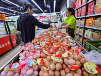 Consumers shop at a supermarket in Qingzhou, China, on October 13, 2024. On October 13, 2024, data released by the National Bureau of Statis...