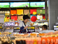 Consumers shop at a supermarket in Qingzhou, China, on October 13, 2024. On October 13, 2024, data released by the National Bureau of Statis...