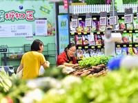 Consumers shop at a supermarket in Qingzhou, China, on October 13, 2024. On October 13, 2024, data released by the National Bureau of Statis...