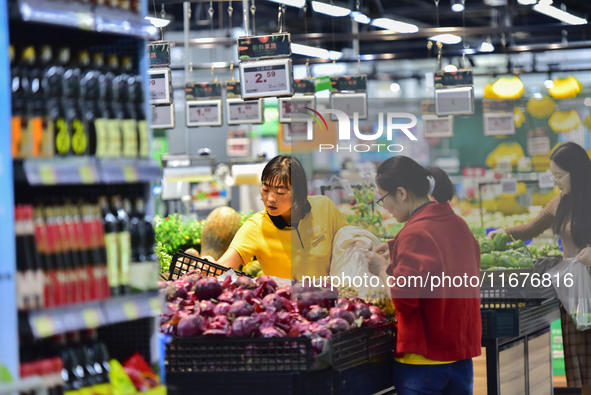 Consumers shop at a supermarket in Qingzhou, China, on October 13, 2024. On October 13, 2024, data released by the National Bureau of Statis...