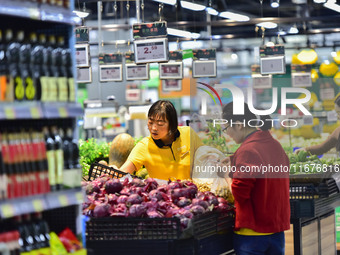 Consumers shop at a supermarket in Qingzhou, China, on October 13, 2024. On October 13, 2024, data released by the National Bureau of Statis...