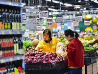 Consumers shop at a supermarket in Qingzhou, China, on October 13, 2024. On October 13, 2024, data released by the National Bureau of Statis...