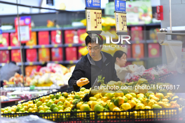 Consumers shop at a supermarket in Qingzhou, China, on October 13, 2024. On October 13, 2024, data released by the National Bureau of Statis...