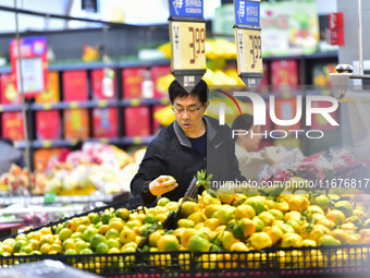 Consumers shop at a supermarket in Qingzhou, China, on October 13, 2024. On October 13, 2024, data released by the National Bureau of Statis...