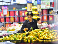 Consumers shop at a supermarket in Qingzhou, China, on October 13, 2024. On October 13, 2024, data released by the National Bureau of Statis...