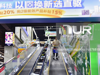 Consumers shop at a supermarket in Qingzhou, China, on October 13, 2024. On October 13, 2024, data released by the National Bureau of Statis...