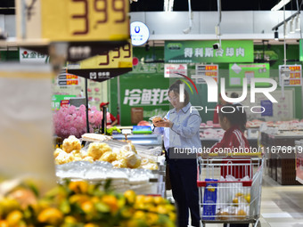 Consumers shop at a supermarket in Qingzhou, China, on October 13, 2024. On October 13, 2024, data released by the National Bureau of Statis...