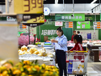 Consumers shop at a supermarket in Qingzhou, China, on October 13, 2024. On October 13, 2024, data released by the National Bureau of Statis...