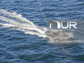 In Gdynia, Poland, on July 31, 2024, Naval Special Operations Unit Formoza soldiers escort a StenaLine ferry on its way from Gdynia, Poland,...