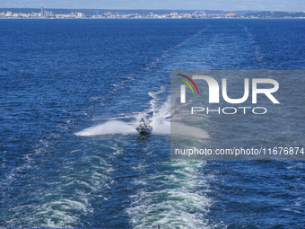 In Gdynia, Poland, on July 31, 2024, Naval Special Operations Unit Formoza soldiers escort a StenaLine ferry on its way from Gdynia, Poland,...