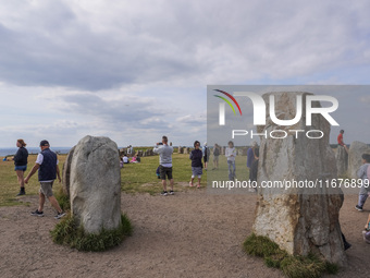 People visit Ales Stenar, also called the Swedish Stonehenge, in Kaseberga, near Ystad, Scane, Sweden, on August 3, 2024. Ales Stenar is a m...