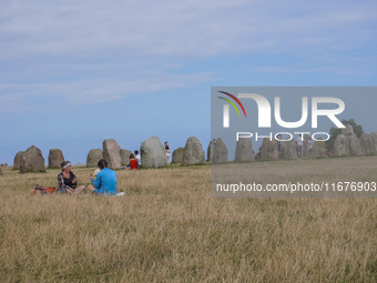 People visit Ales Stenar, also called the Swedish Stonehenge, in Kaseberga, near Ystad, Scane, Sweden, on August 3, 2024. Ales Stenar is a m...