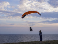 A paraglider flies over the Baltic Sea in Kaseberga, near Ystad, Scane, Sweden, on August 3, 2024. Ales Stenar, also called Swedish Stonehen...