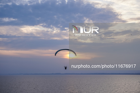 Paragliders fly over the Baltic Sea in Kaseberga, near Ystad, Scane, Sweden, on August 3, 2024. Ales Stenar, also called the Swedish Stonehe...