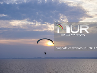 Paragliders fly over the Baltic Sea in Kaseberga, near Ystad, Scane, Sweden, on August 3, 2024. Ales Stenar, also called the Swedish Stonehe...