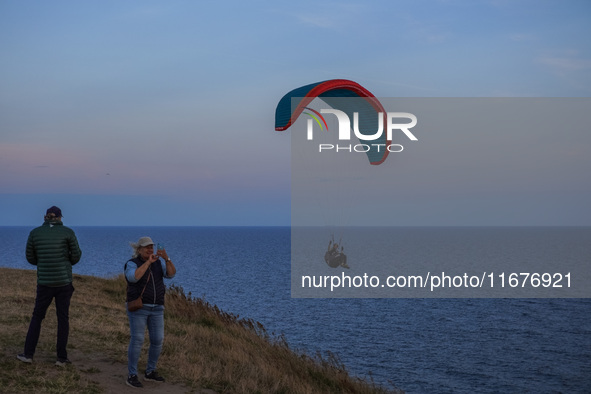 A paraglider flies over the Baltic Sea in Kaseberga, near Ystad, Scane, Sweden, on August 3, 2024. Ales Stenar, also called Swedish Stonehen...