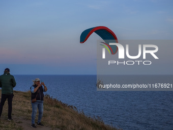 A paraglider flies over the Baltic Sea in Kaseberga, near Ystad, Scane, Sweden, on August 3, 2024. Ales Stenar, also called Swedish Stonehen...