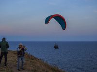 A paraglider flies over the Baltic Sea in Kaseberga, near Ystad, Scane, Sweden, on August 3, 2024. Ales Stenar, also called Swedish Stonehen...