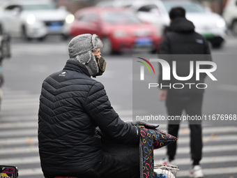 In Shenyang, China, on October 18, 2024, people change into thick clothes to travel after the rain. (