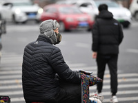 In Shenyang, China, on October 18, 2024, people change into thick clothes to travel after the rain. (