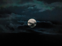 The Full Moon of the Hunter is in the cloudy sky near Andria, Apulia, on October 17, 2024. (