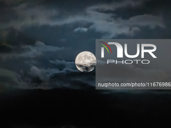 The Full Moon of the Hunter is in the cloudy sky near Andria, Apulia, on October 17, 2024. (