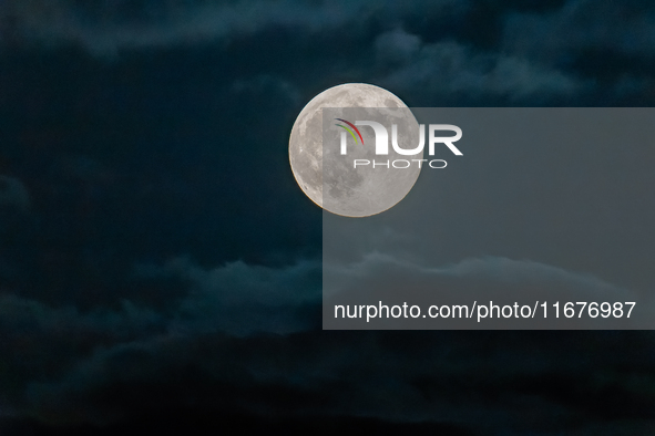 The Full Moon of the Hunter is in the cloudy sky near Andria, Apulia, on October 17, 2024. 