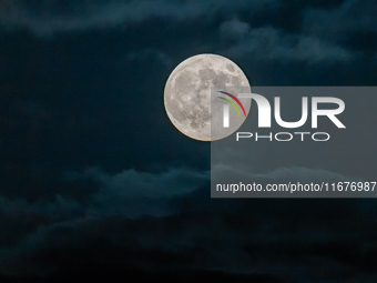 The Full Moon of the Hunter is in the cloudy sky near Andria, Apulia, on October 17, 2024. (