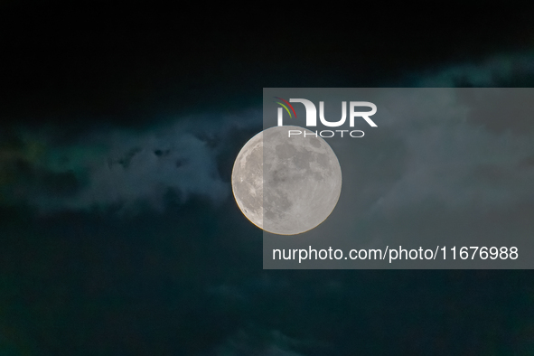 The Full Moon of the Hunter is in the cloudy sky near Andria, Apulia, on October 17, 2024. 