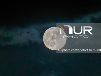 The Full Moon of the Hunter is in the cloudy sky near Andria, Apulia, on October 17, 2024. (