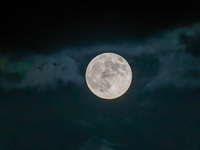 The Full Moon of the Hunter is in the cloudy sky near Andria, Apulia, on October 17, 2024. (