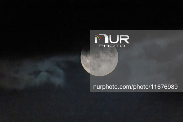 The Full Moon of the Hunter is in the cloudy sky near Andria, Apulia, on October 17, 2024. 