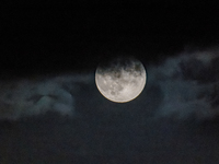 The Full Moon of the Hunter is in the cloudy sky near Andria, Apulia, on October 17, 2024. (