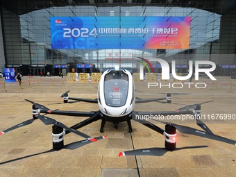 An unmanned electric vertical take-off and landing aircraft is displayed at the 2024 China International Consumer Electronics Expo in Qingda...