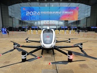 An unmanned electric vertical take-off and landing aircraft is displayed at the 2024 China International Consumer Electronics Expo in Qingda...