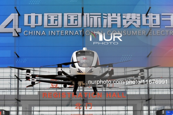 An unmanned electric vertical take-off and landing aircraft is displayed at the 2024 China International Consumer Electronics Expo in Qingda...