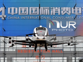 An unmanned electric vertical take-off and landing aircraft is displayed at the 2024 China International Consumer Electronics Expo in Qingda...