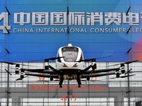 An unmanned electric vertical take-off and landing aircraft is displayed at the 2024 China International Consumer Electronics Expo in Qingda...