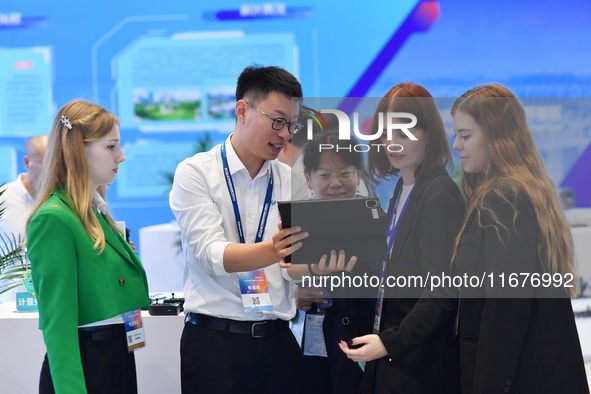 Several foreign visitors learn about the park's digital twin information system at the 2024 China International Consumer Electronics Expo in...