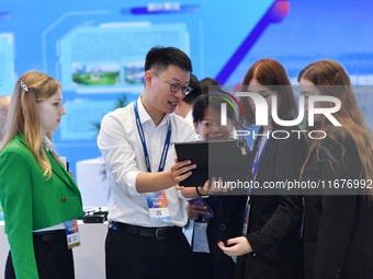 Several foreign visitors learn about the park's digital twin information system at the 2024 China International Consumer Electronics Expo in...