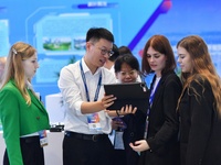 Several foreign visitors learn about the park's digital twin information system at the 2024 China International Consumer Electronics Expo in...