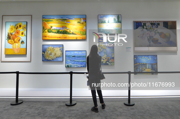 Visitors look at the Hisense Art TV display wall at the 2024 China International Consumer Electronics Expo in Qingdao, China, on October 18,...