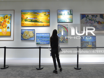 Visitors look at the Hisense Art TV display wall at the 2024 China International Consumer Electronics Expo in Qingdao, China, on October 18,...