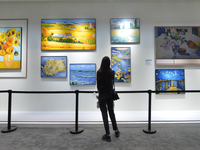 Visitors look at the Hisense Art TV display wall at the 2024 China International Consumer Electronics Expo in Qingdao, China, on October 18,...