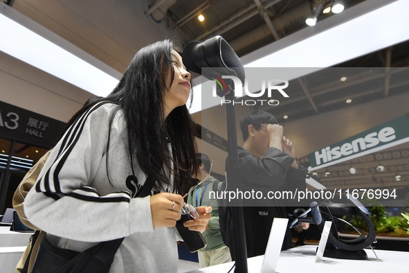 Visitors experience 4K ultra-thin and low-power VR at the 2024 China International Consumer Electronics Expo in Qingdao, China, on October 1...