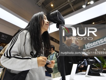 Visitors experience 4K ultra-thin and low-power VR at the 2024 China International Consumer Electronics Expo in Qingdao, China, on October 1...