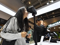 Visitors experience 4K ultra-thin and low-power VR at the 2024 China International Consumer Electronics Expo in Qingdao, China, on October 1...