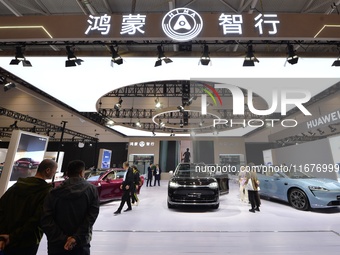 Visitors visit the Huawei HarmonyOS Smart Home Car booth at the 2024 China International Consumer Electronics Expo in Qingdao, China, on Oct...