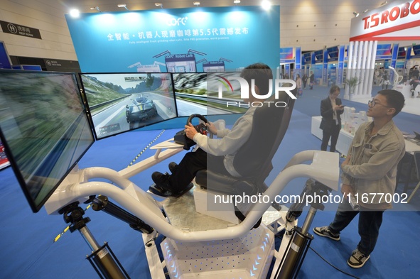 Visitors experience a three-screen six-axis racing demonstration system at the 2024 China International Consumer Electronics Expo in Qingdao...