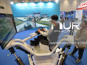 Visitors experience a three-screen six-axis racing demonstration system at the 2024 China International Consumer Electronics Expo in Qingdao...